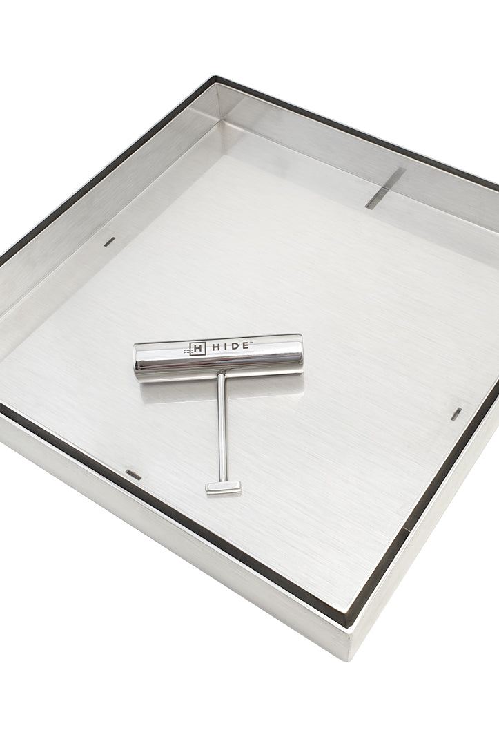 HIDE drain cover hardware showing frame, inlay tray and one safety key