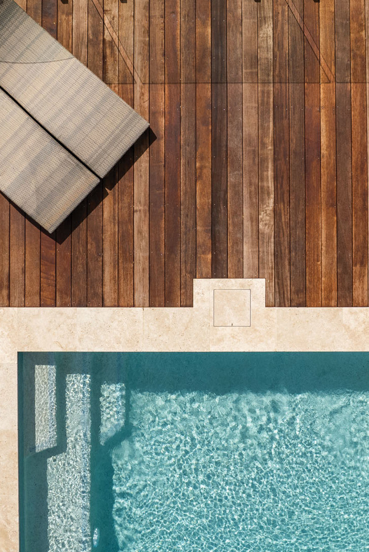 Aerial view of pool deck showing a HIDE Skimmer Cover with matching coping infill