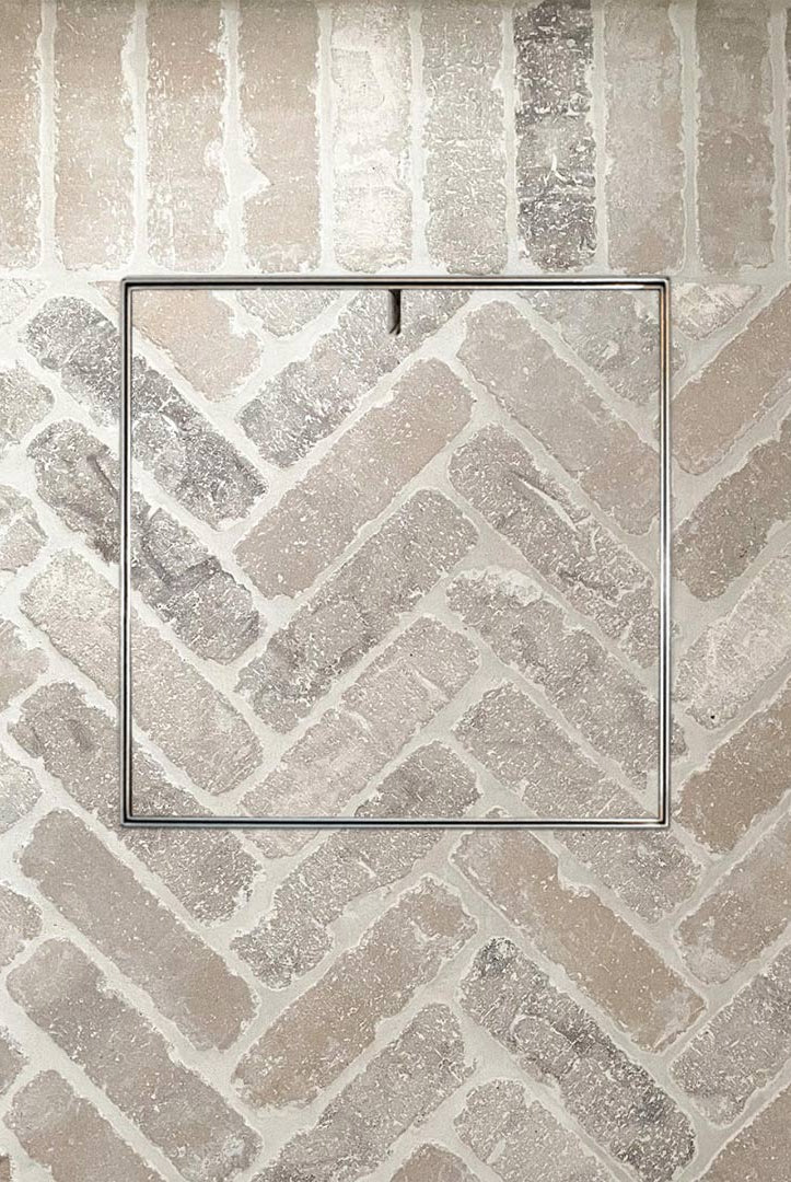 Amazing HIDE Access Cover with matching brick infill in herringbone pattern