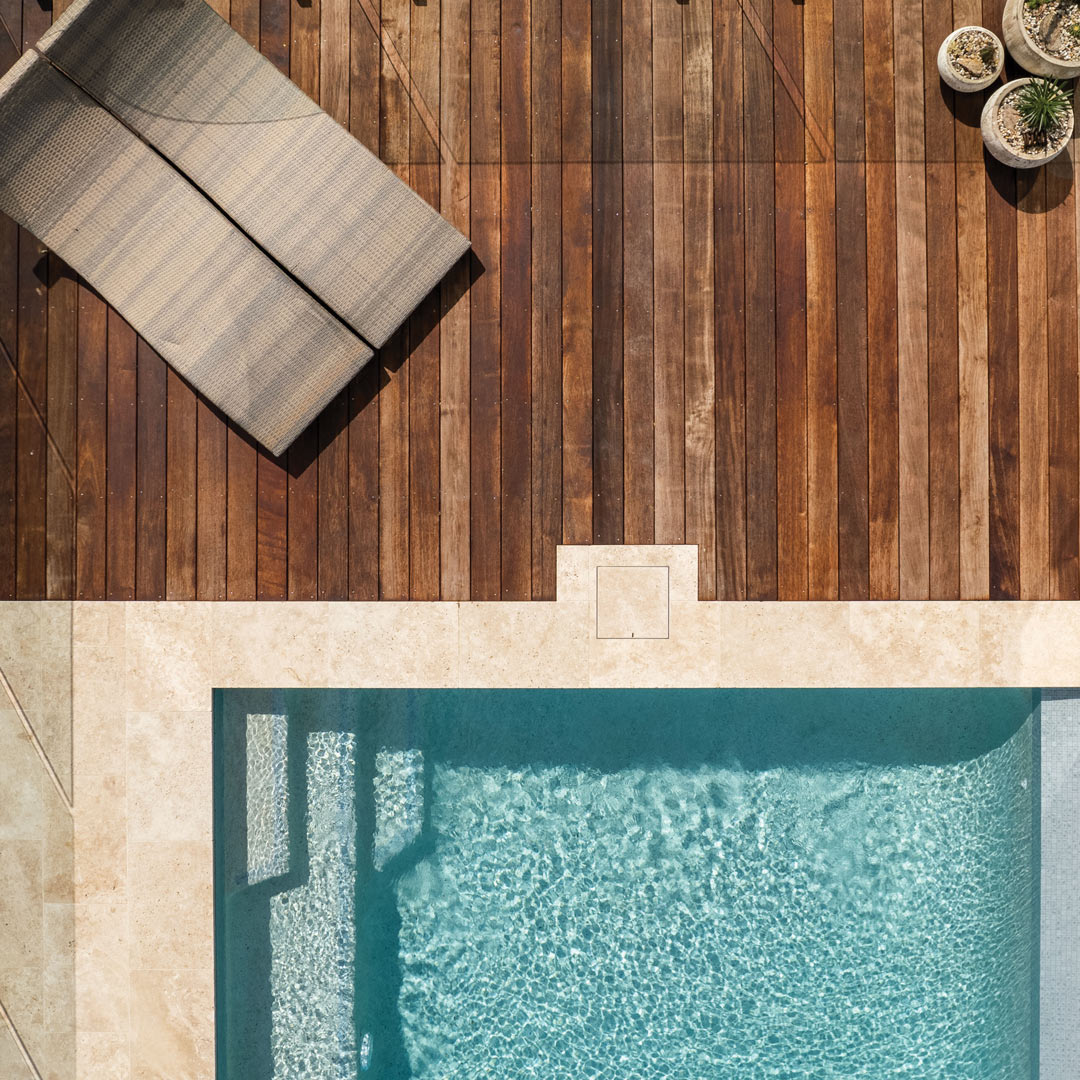 Aerial view of pool deck showing a HIDE Skimmer Cover with matching coping infill