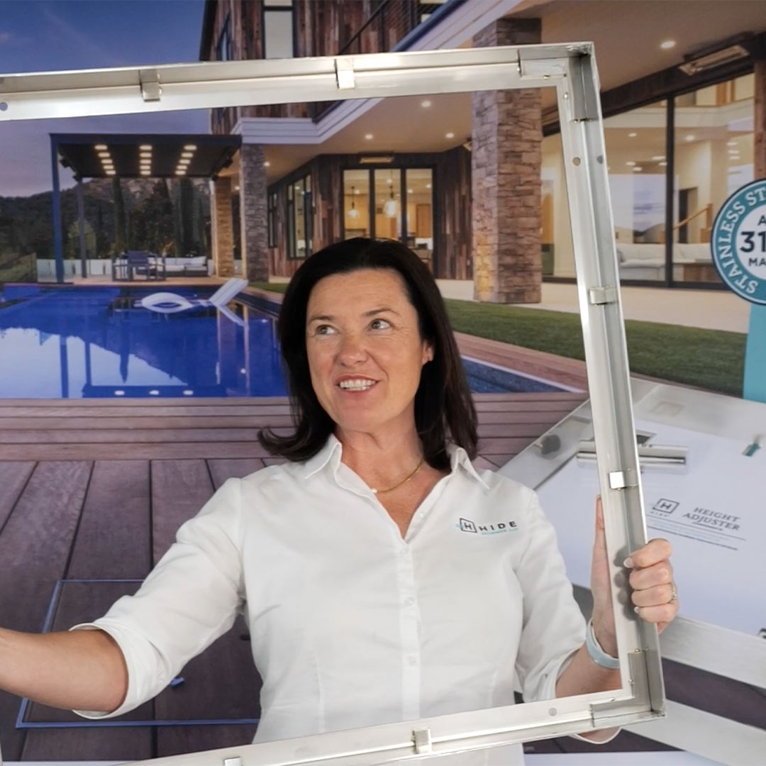 HIDE sales representative holding large 656mm Manhole Cover frame showing how large it is.