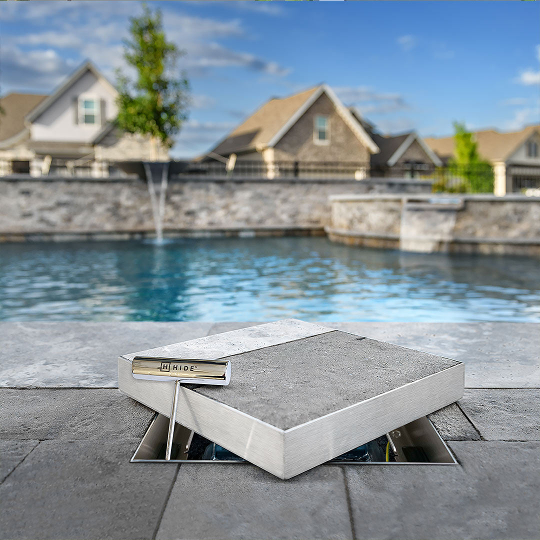 HIDE Skimmer Cover on a patio with houses and pool in the background.